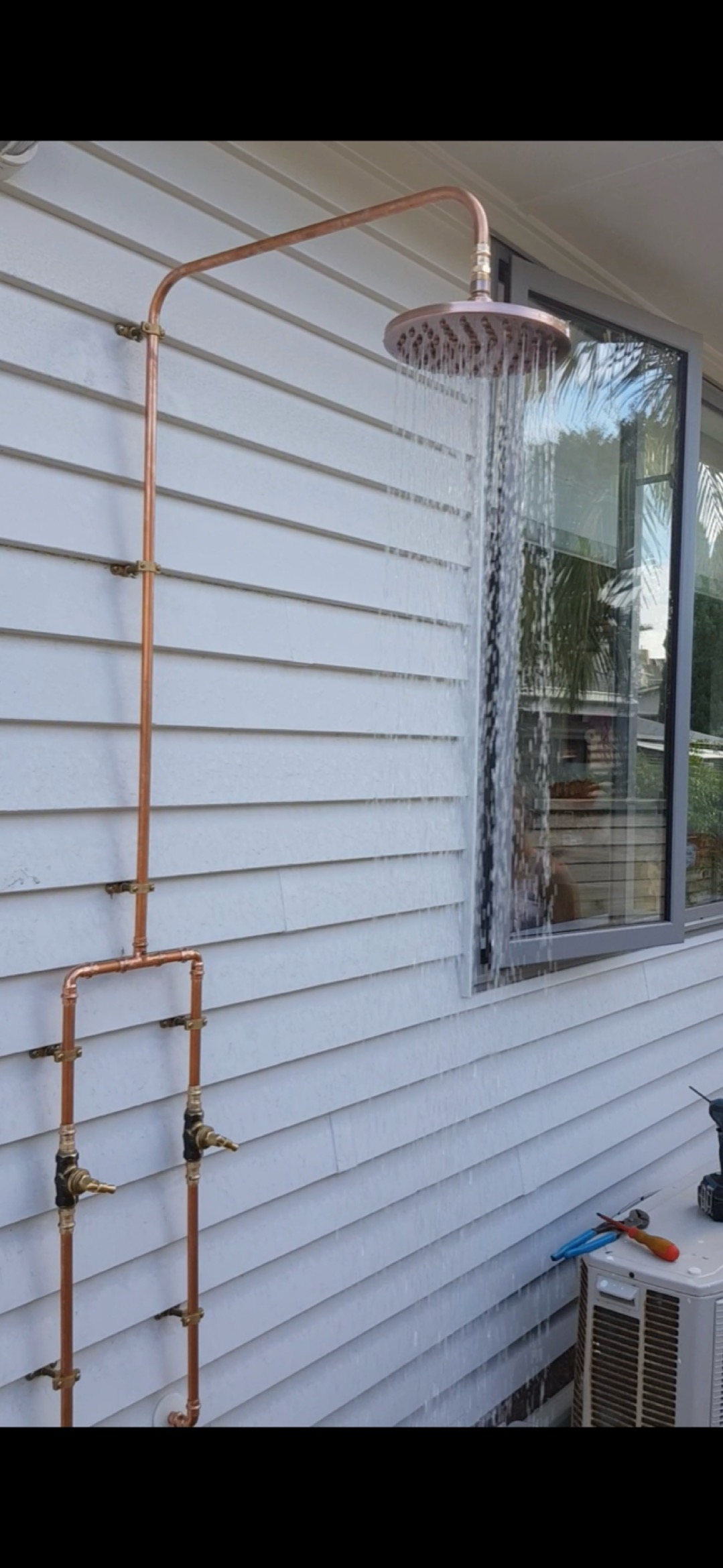 Outdoor shower installation in a residential exterior area
