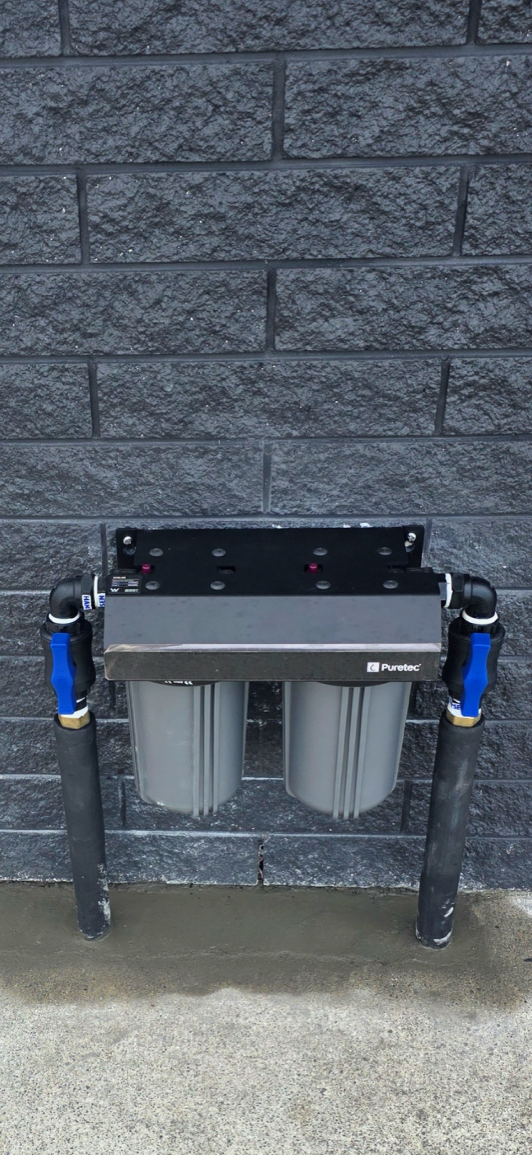 Puretec inline dual filter house system installed to filter water before it enters the home
